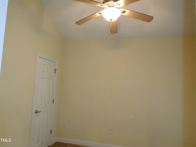 empty room featuring ceiling fan and lofted ceiling