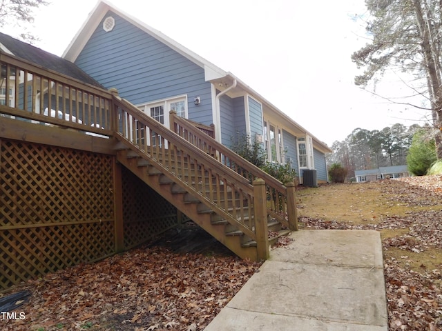 view of side of home with cooling unit and a wooden deck