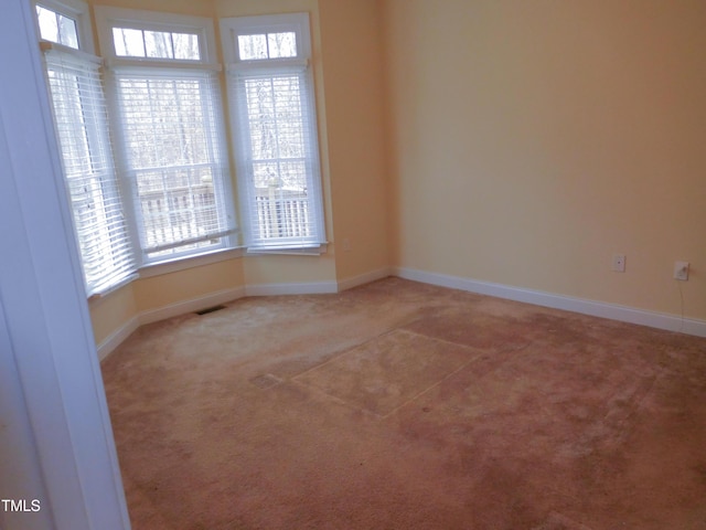 spare room with carpet flooring and a healthy amount of sunlight