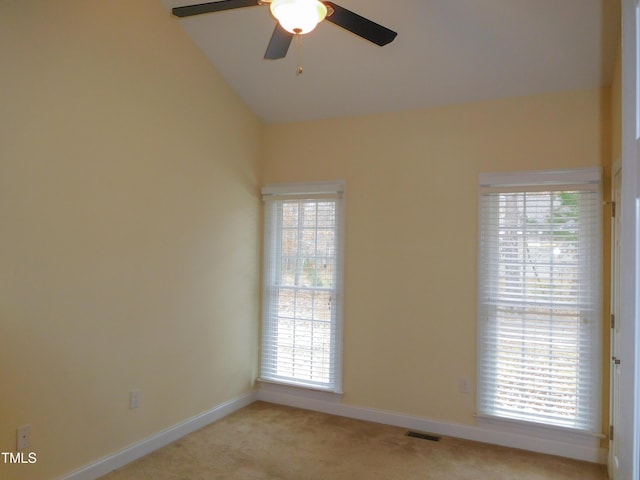 unfurnished room featuring light carpet, ceiling fan, and vaulted ceiling