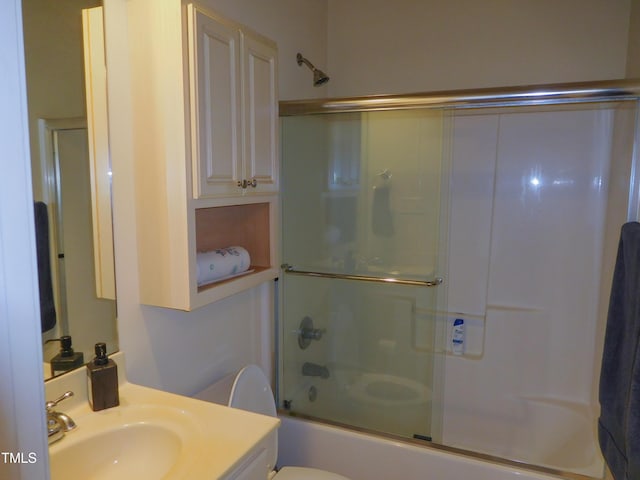 full bathroom featuring vanity, toilet, and enclosed tub / shower combo