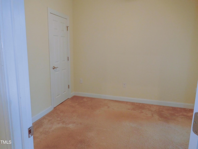 unfurnished room featuring light colored carpet