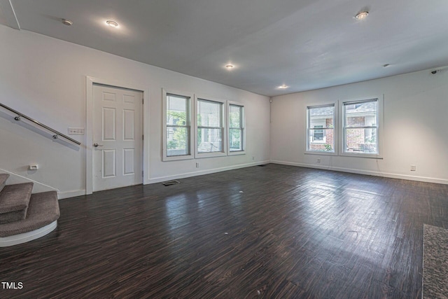 unfurnished living room featuring dark hardwood / wood-style floors