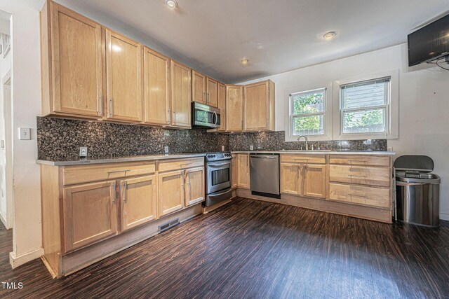 kitchen with dark hardwood / wood-style floors, decorative backsplash, stainless steel appliances, and light brown cabinetry