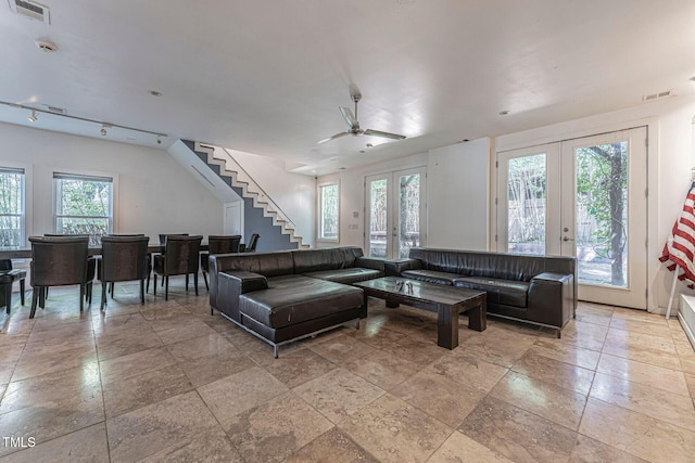 living room featuring ceiling fan and french doors