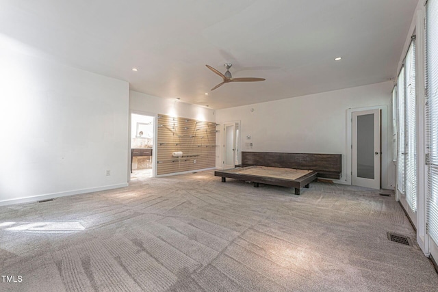 unfurnished living room with ceiling fan and light colored carpet