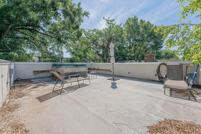 view of patio / terrace featuring a hot tub