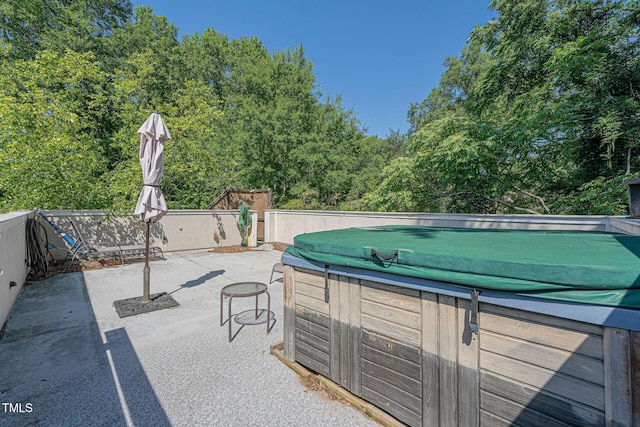 view of pool featuring a hot tub and a patio area