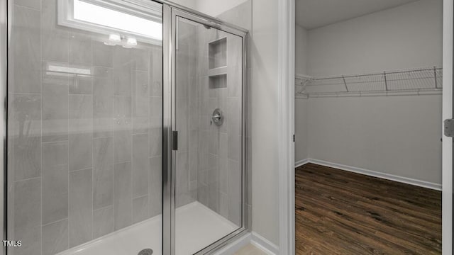 bathroom featuring hardwood / wood-style floors and a shower with door