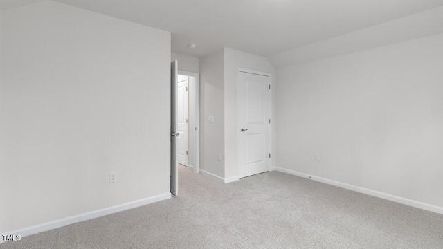 empty room featuring light colored carpet