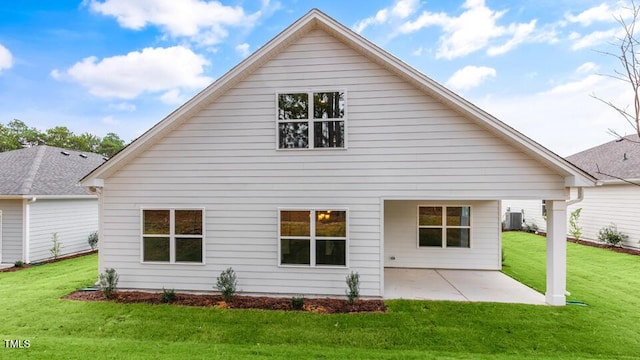 back of house with a yard, a patio area, and central air condition unit