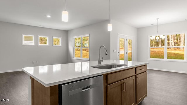 kitchen with stainless steel dishwasher, a kitchen island with sink, a healthy amount of sunlight, and sink