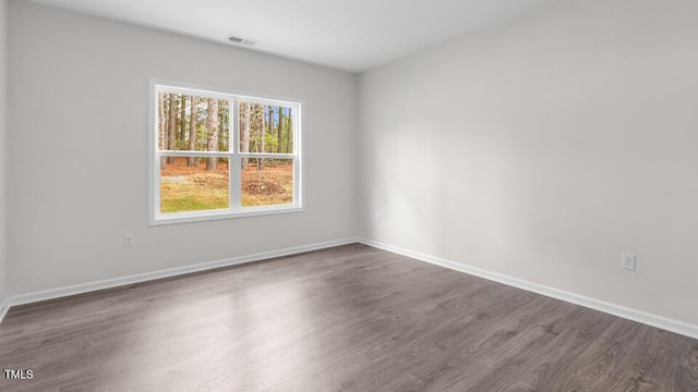 spare room with dark hardwood / wood-style floors