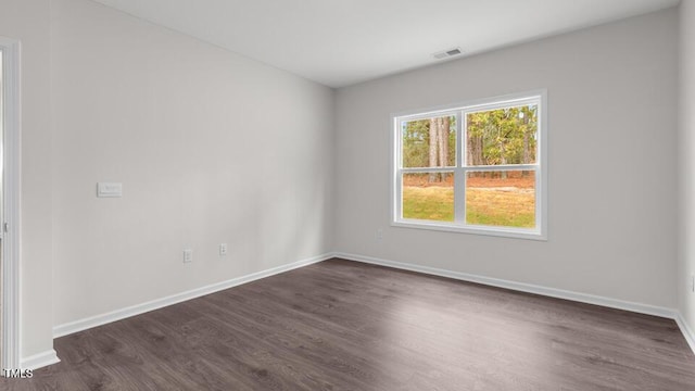 empty room with dark wood-type flooring