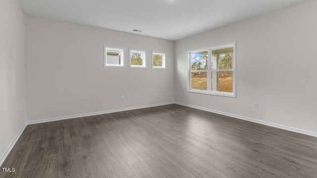 empty room featuring dark wood-type flooring