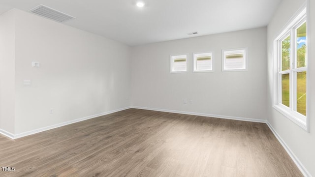 spare room featuring wood-type flooring