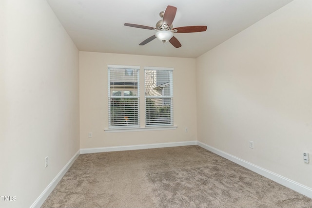 carpeted spare room with ceiling fan