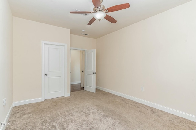 unfurnished bedroom featuring ceiling fan and light colored carpet