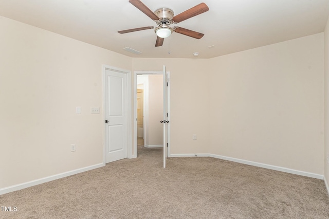 empty room with ceiling fan and light colored carpet