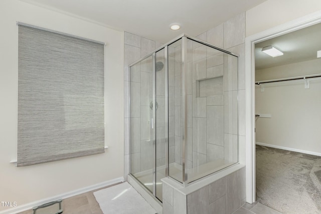 bathroom featuring a shower with shower door