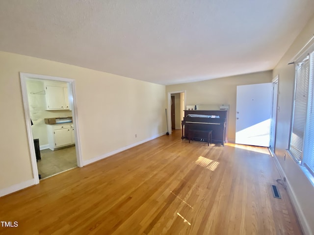 unfurnished living room with light hardwood / wood-style flooring