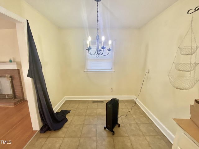 dining space with tile patterned floors and an inviting chandelier