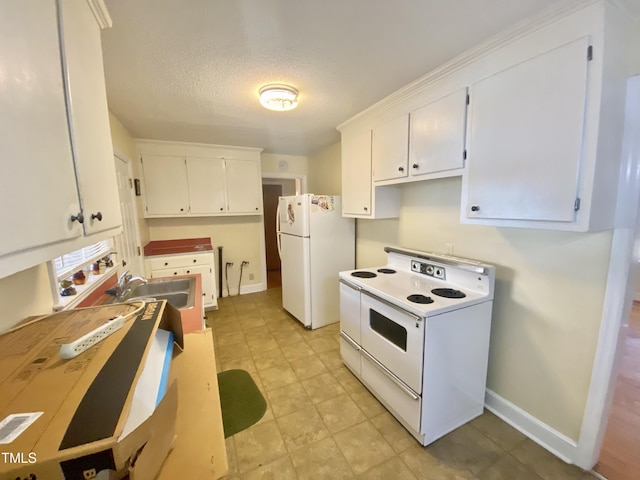 kitchen with white cabinets, white appliances, sink, and a textured ceiling