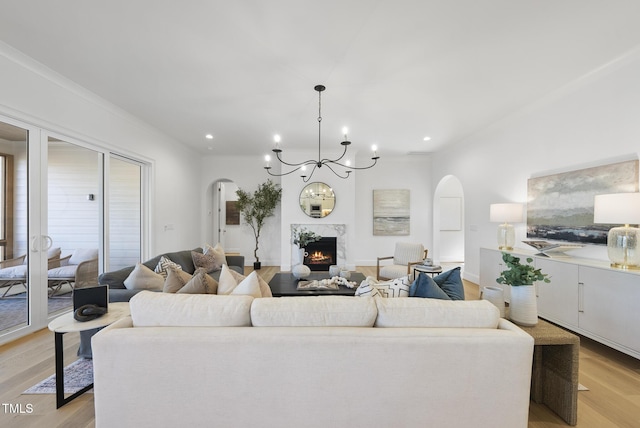 living room featuring light wood-type flooring and an inviting chandelier