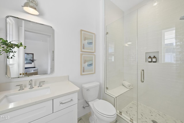 bathroom with vanity, toilet, and a shower with shower door