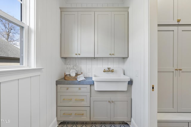 interior space with gray cabinets and sink