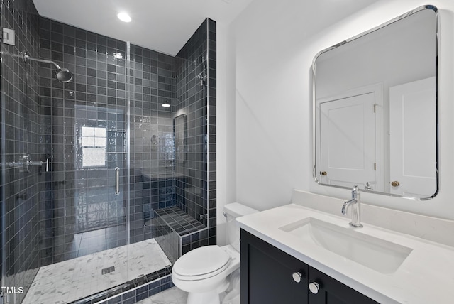 bathroom featuring vanity, toilet, and an enclosed shower