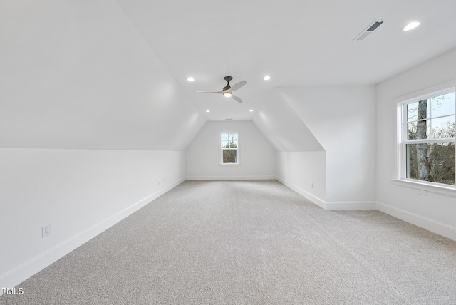 bonus room with ceiling fan, lofted ceiling, and light carpet