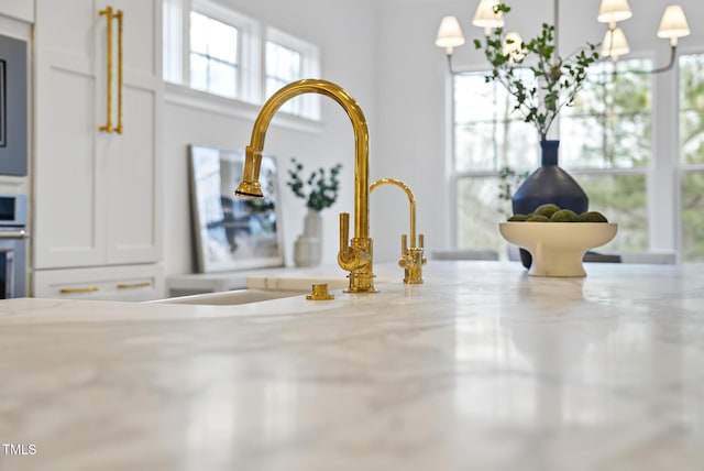 details with light stone countertops and pendant lighting