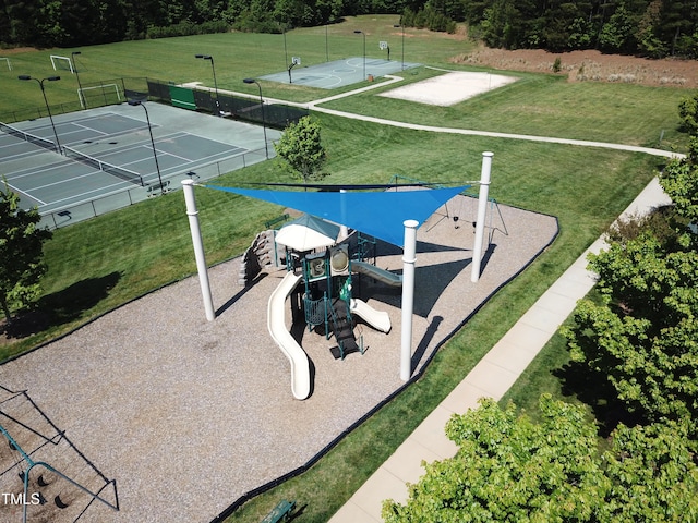 exterior space featuring tennis court and a playground