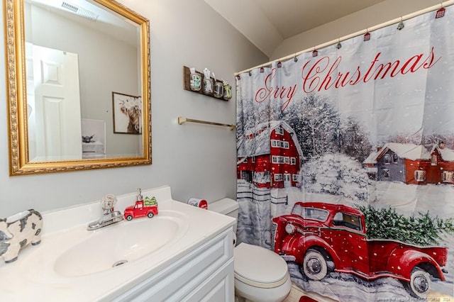 bathroom featuring vanity, toilet, and curtained shower