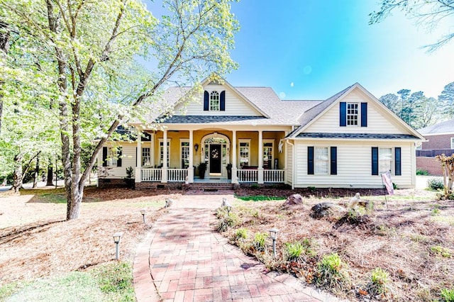 view of front of house with covered porch and roof with shingles