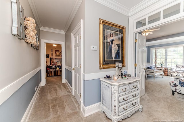 corridor featuring baseboards, light colored carpet, and crown molding