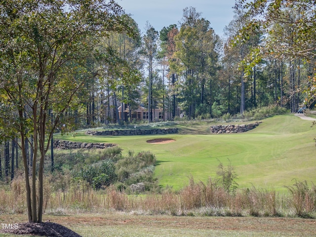 view of home's community featuring a yard and golf course view