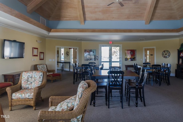 carpeted dining space featuring crown molding, wooden ceiling, ceiling fan, and french doors