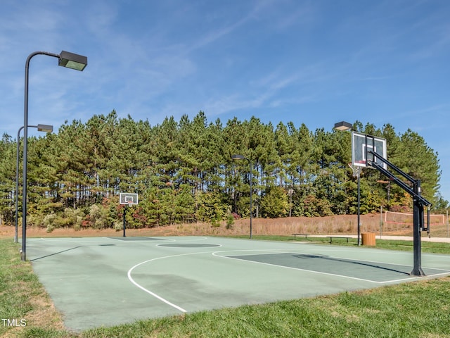 view of basketball court featuring community basketball court and fence