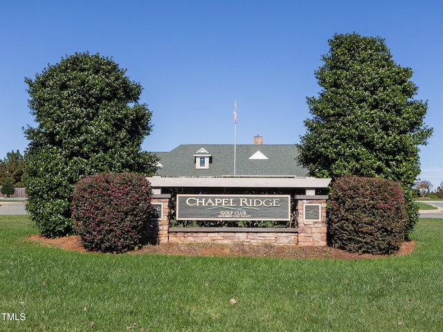 community sign featuring a lawn