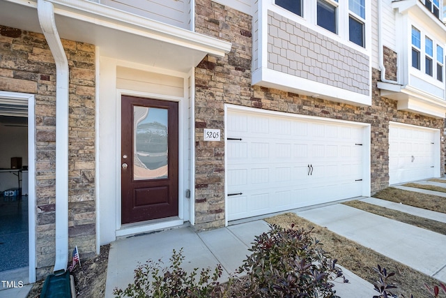 view of exterior entry with a garage