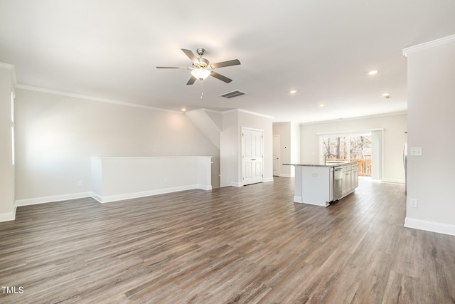 unfurnished living room featuring ceiling fan, dark wood-type flooring, and crown molding