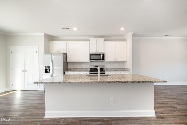 kitchen featuring a center island with sink, sink, light stone countertops, appliances with stainless steel finishes, and white cabinets