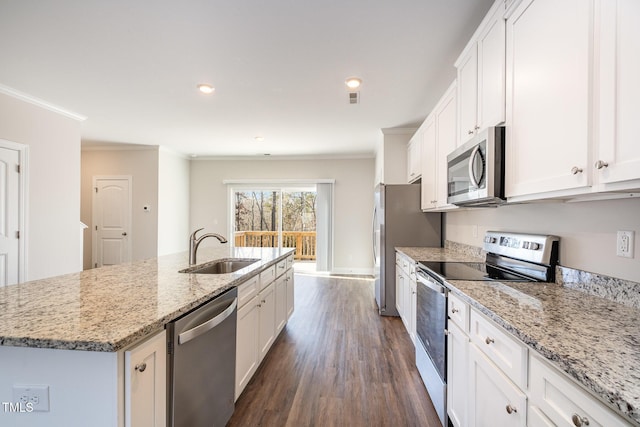 kitchen featuring stainless steel appliances, a kitchen island with sink, white cabinets, and sink