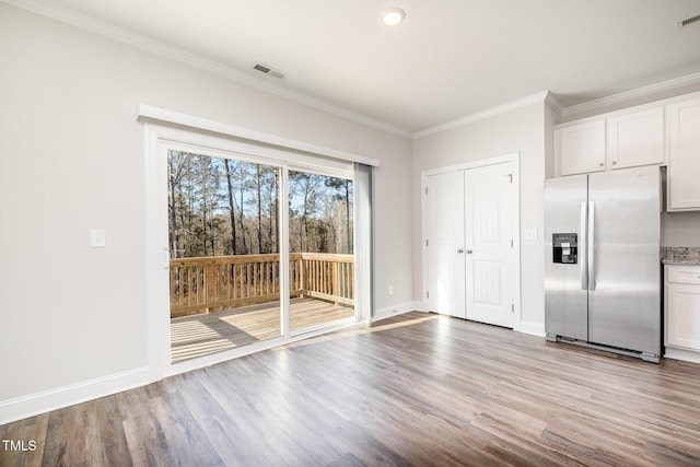 kitchen featuring stainless steel refrigerator with ice dispenser, ornamental molding, light hardwood / wood-style floors, and white cabinets