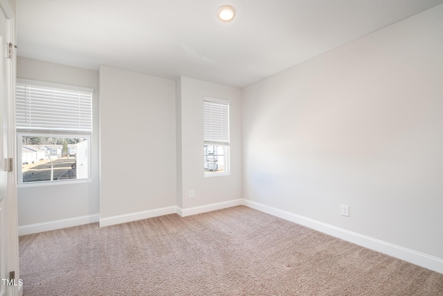 carpeted empty room with a wealth of natural light