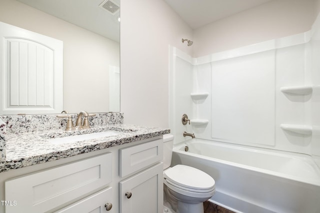 full bathroom featuring washtub / shower combination, vanity, and toilet