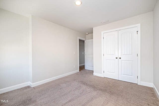 unfurnished bedroom featuring a closet and carpet