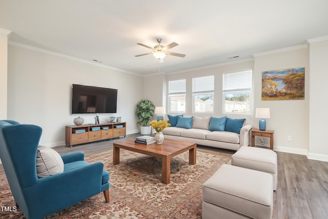 living room featuring ceiling fan, wood-type flooring, and ornamental molding